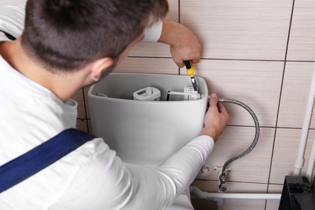 Man fixing a toilet flusher