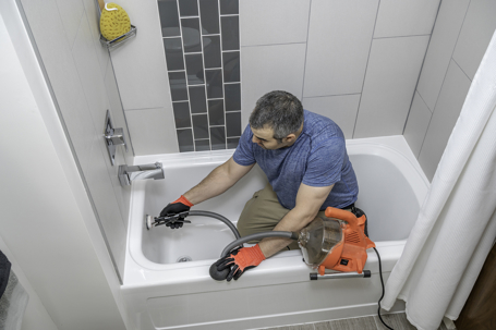 Technician inspecting Bathtub Drain