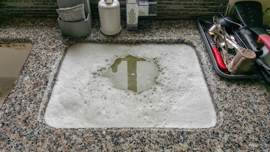 Clogged sink full of bubbly water